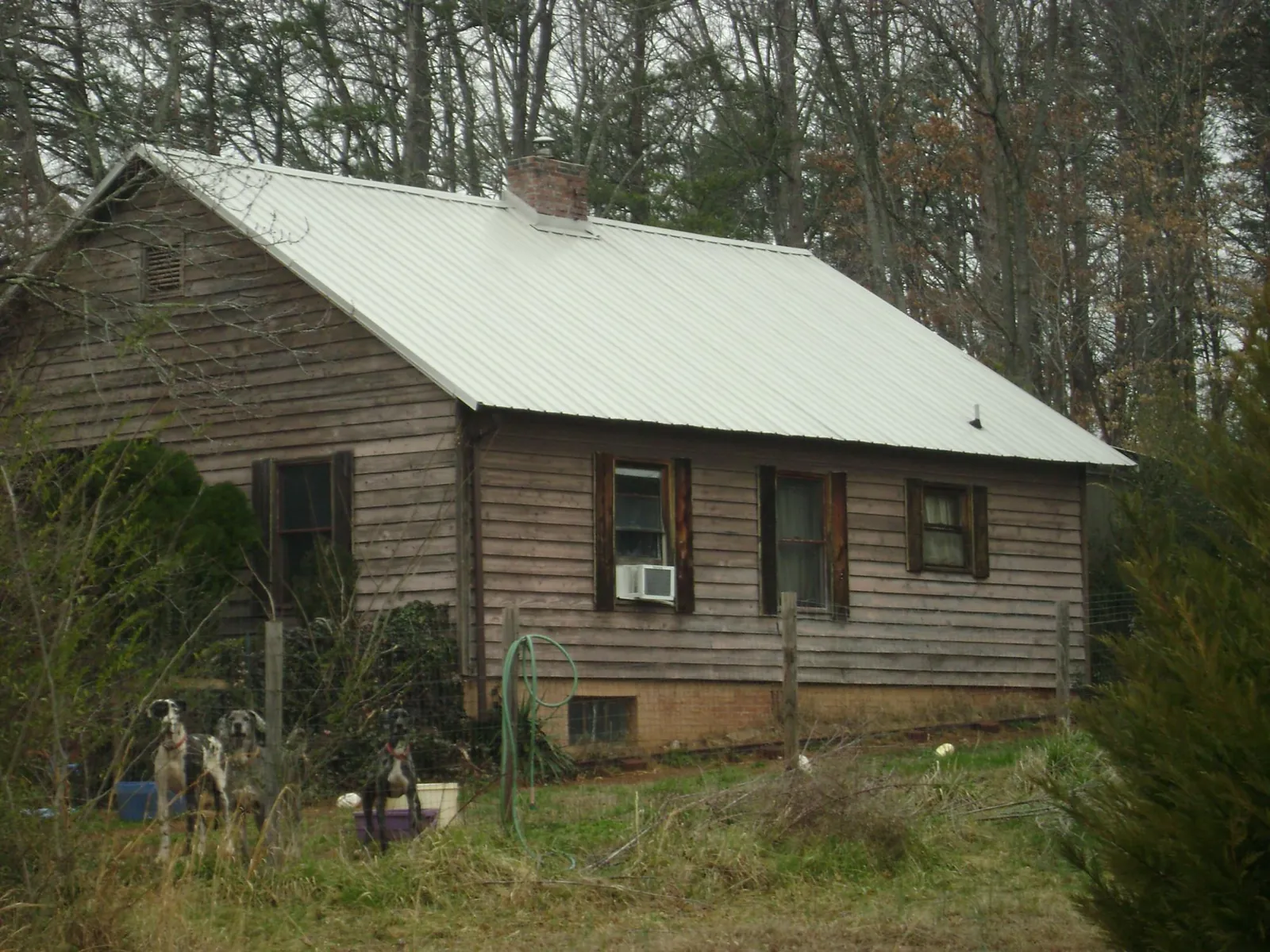 White metal roof on an old wood sided farmhouse, from a Metal Roof Installation job in Independence